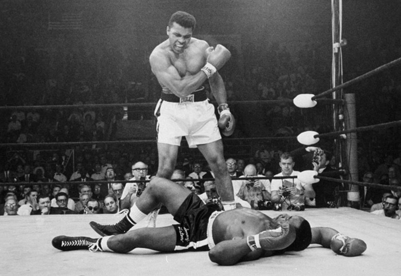 Muhammad Ali looks at Sonny Liston on the canvas.